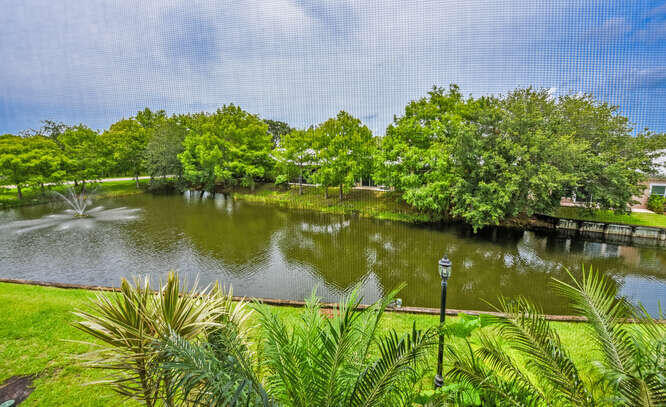 Undisclosed Address Stuart, FL 34994 - Photo 20 of 41 a view of a lake with a garden