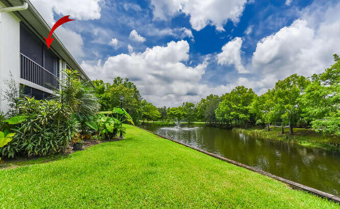 Undisclosed Address Stuart, FL 34994 - Photo 23 of 41 a view of a lake with a house in the background