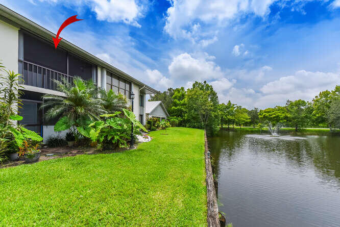 Undisclosed Address Stuart, FL 34994 - Photo 24 of 41 a backyard of a house with plants and lake view