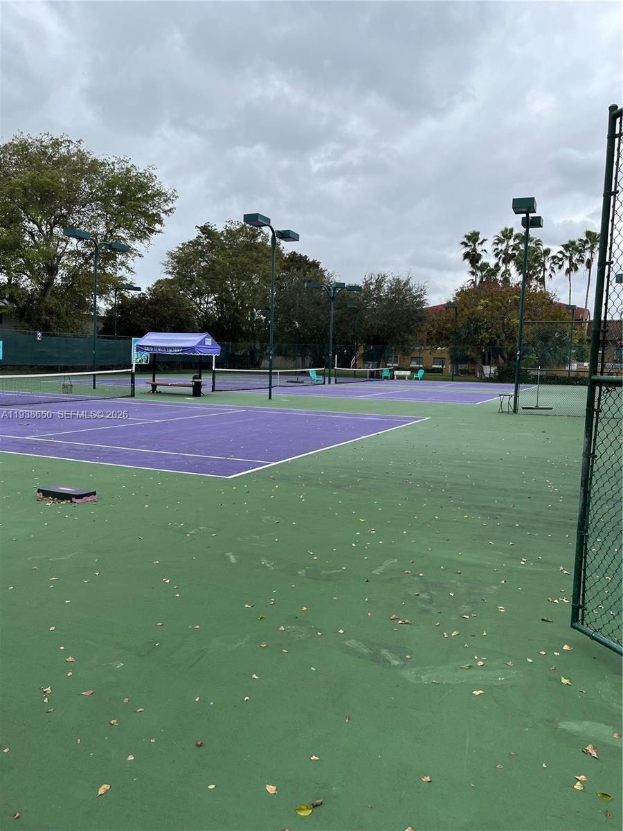 15630 Southwest 80th Street, Unit I110 Miami, FL 33193 - Photo 26 of 28 a swimming pool with outdoor seating and trees
