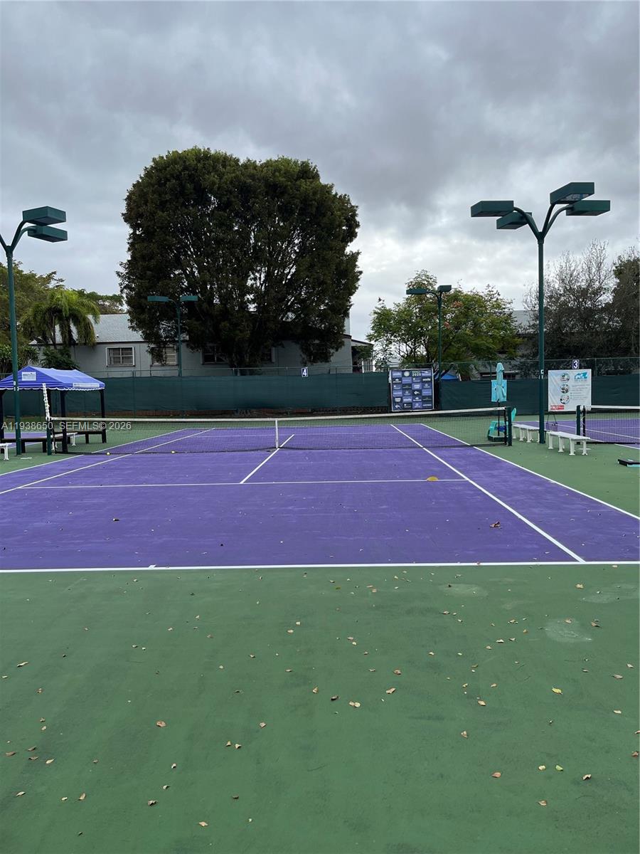 15630 Southwest 80th Street, Unit I110 Miami, FL 33193 - Photo 27 of 28 a tennis court that has trees in the background