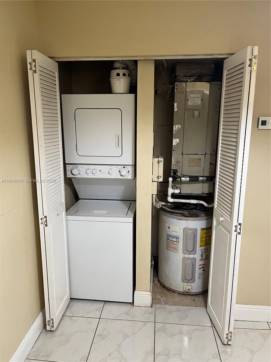 15630 Southwest 80th Street, Unit I110 Miami, FL 33193 - Photo 9 of 28 a utility room with dryer and washer