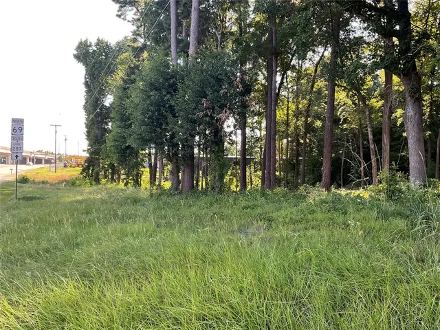 a view of outdoor space with green field and trees