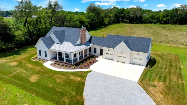 a aerial view of a house with swimming pool and big yard
