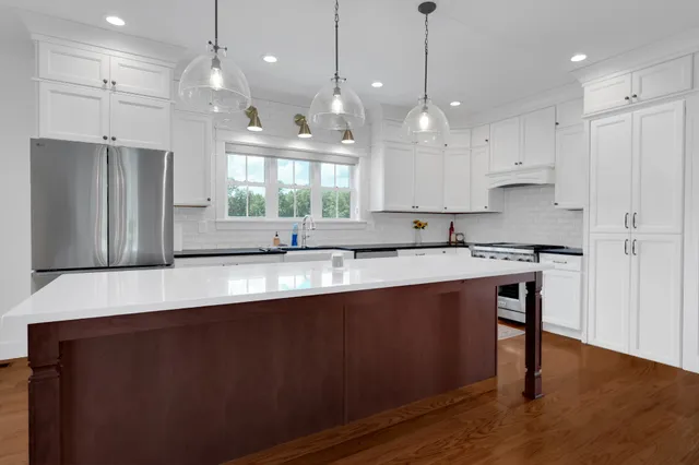 a kitchen with granite countertop a stove top oven sink and cabinets