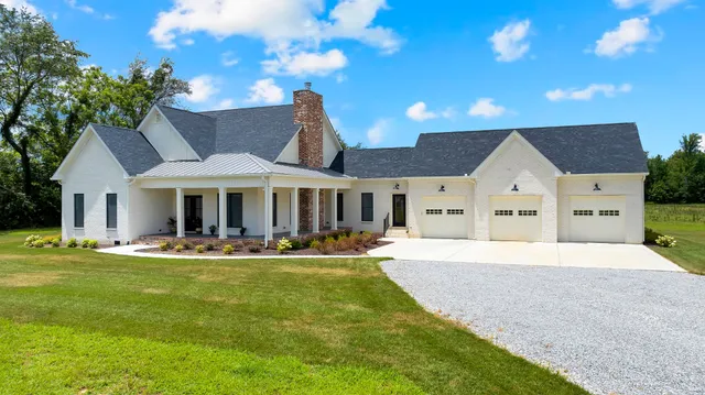 a front view of a house with a garden and yard