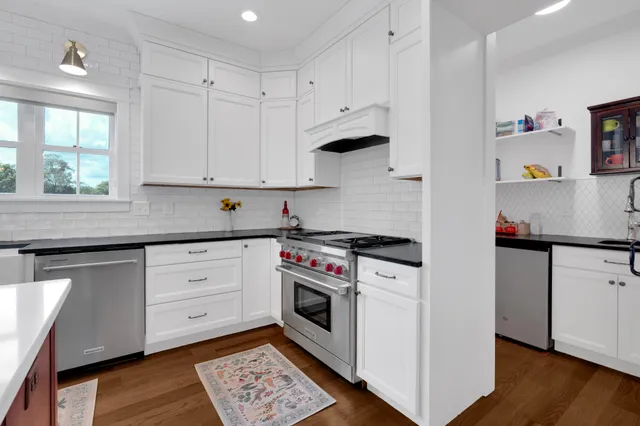 a large kitchen with lots of counter space dining table and chairs
