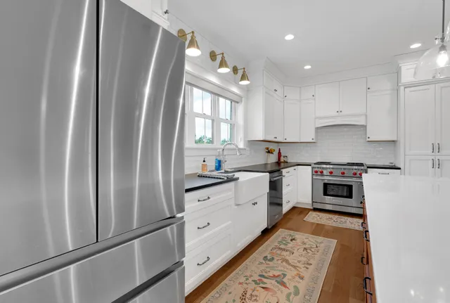a spacious bathroom with a tub sink and mirror