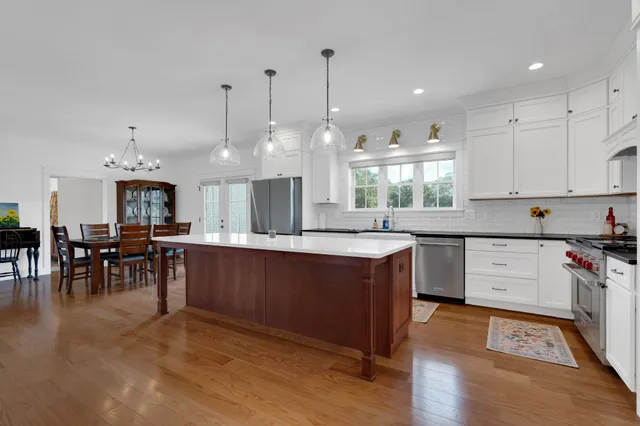 a bathroom with a tub a sink and mirror