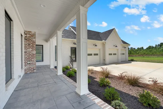 a living room with furniture a table and a large window