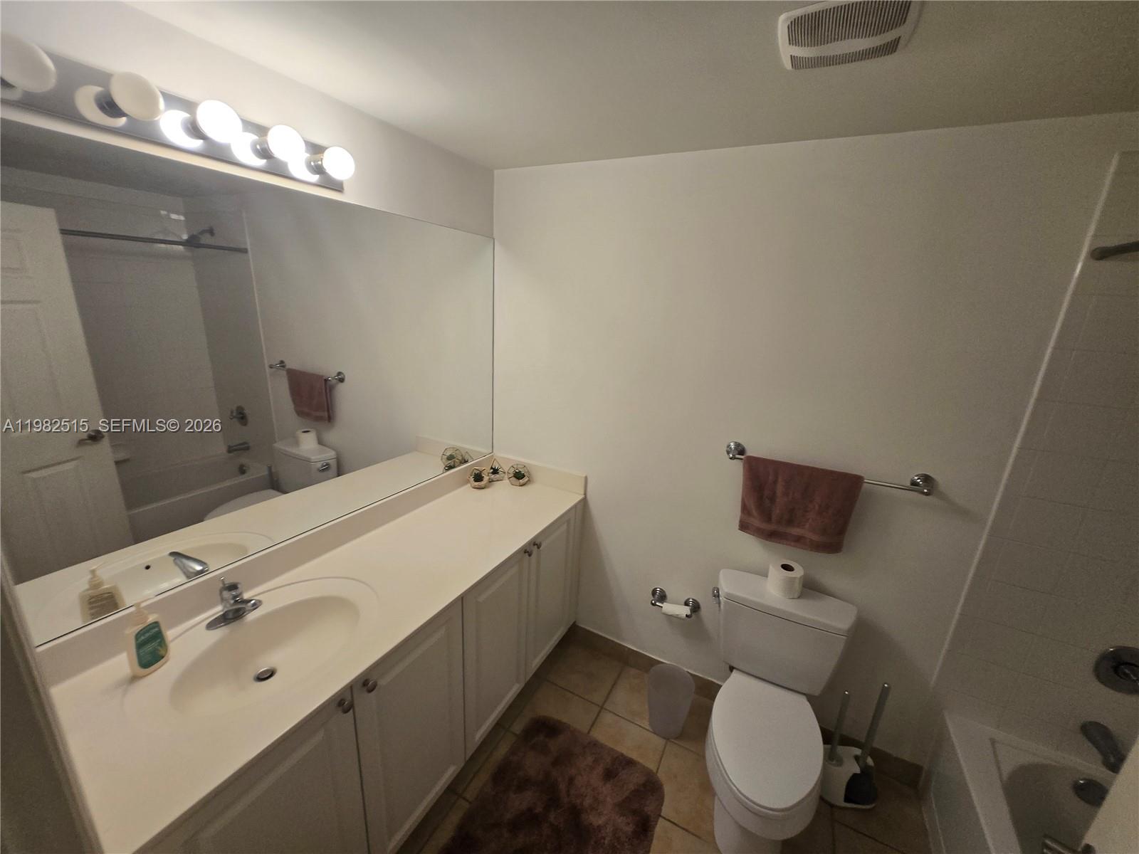 888 Douglas Road, Unit 405 Coral Gables, FL 33134 - Photo 14 of 24 a bathroom with a sink mirror and toilet