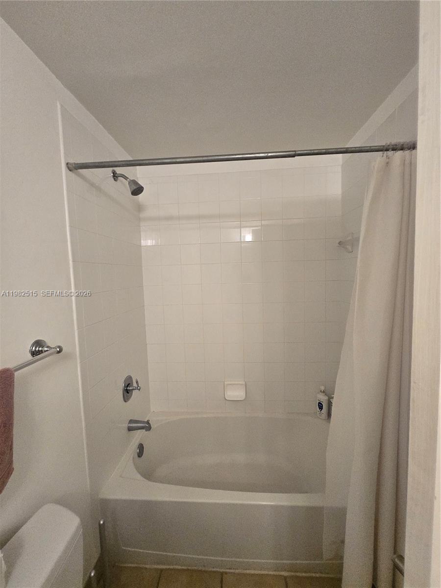 888 Douglas Road, Unit 405 Coral Gables, FL 33134 - Photo 15 of 24 a bathroom with a shower and a toilet