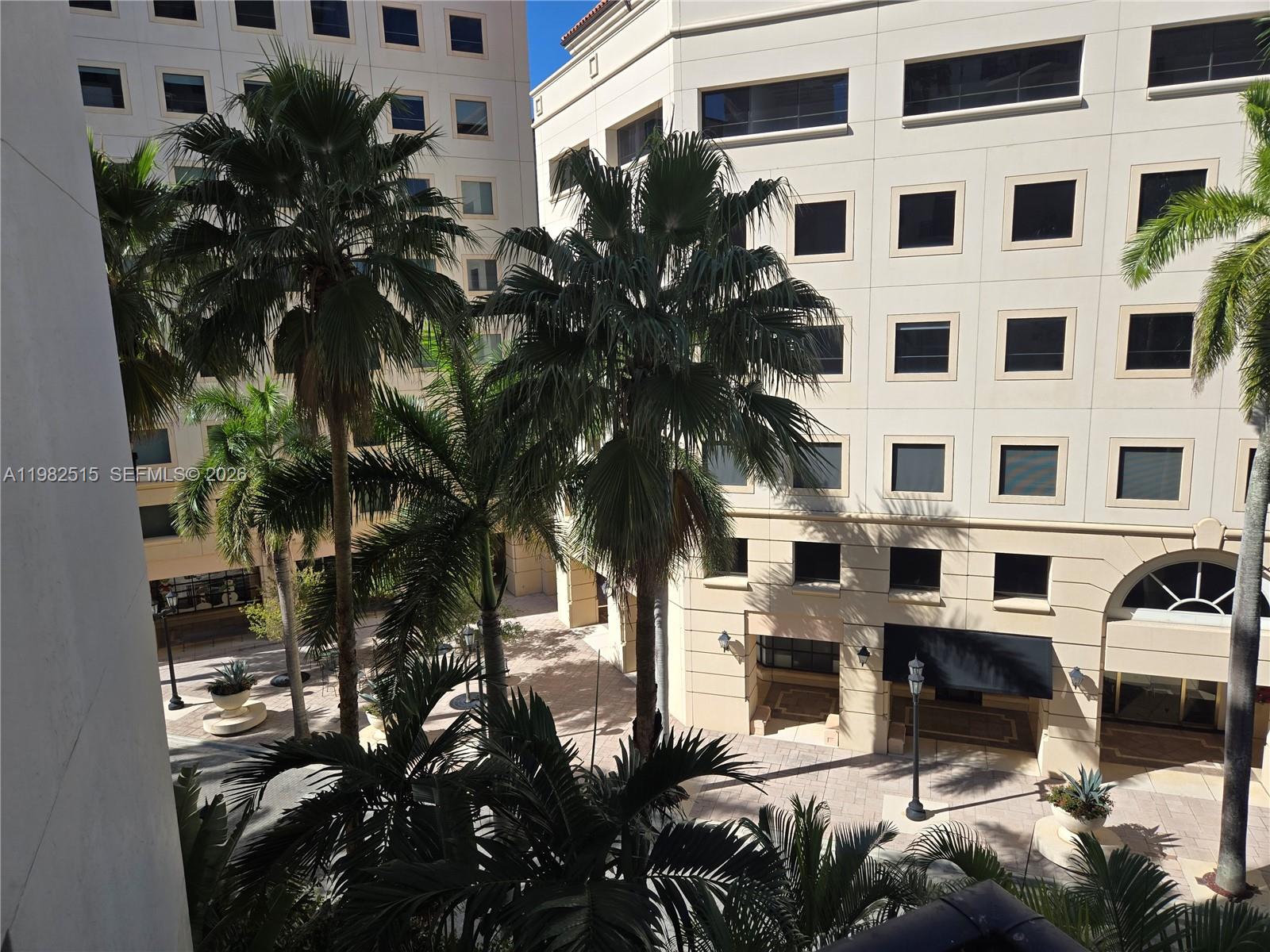 888 Douglas Road, Unit 405 Coral Gables, FL 33134 - Photo 17 of 24 a view of building with yard and car parked