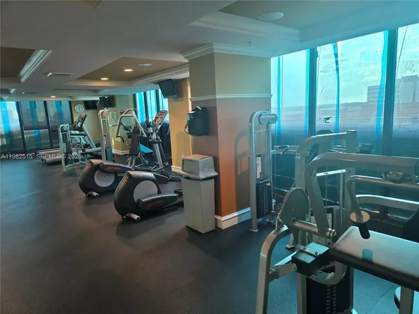 a very nice looking room with many windows and furniture