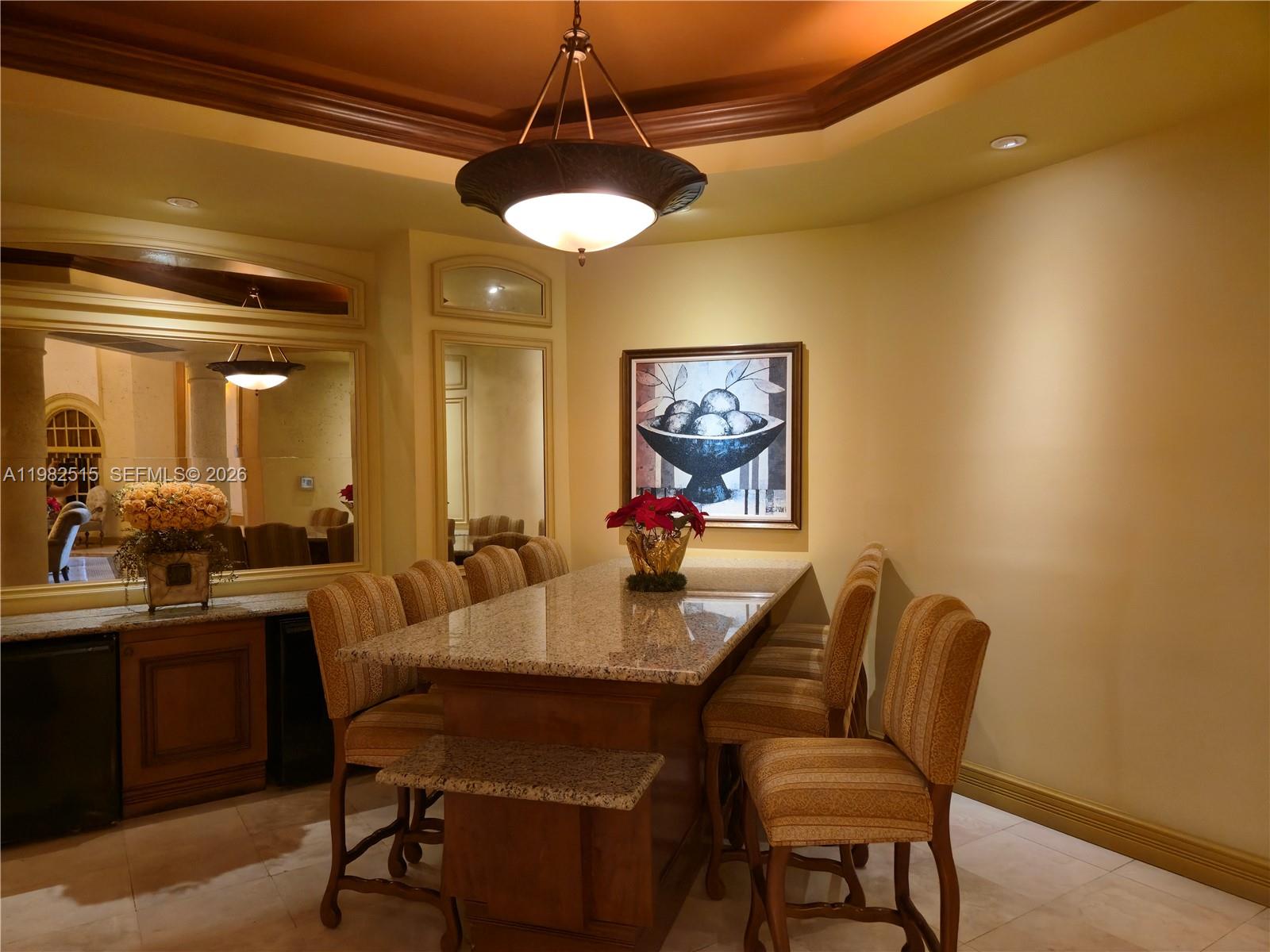 888 Douglas Road, Unit 405 Coral Gables, FL 33134 - Photo 23 of 24 a view of a dining room with furniture and a chandelier