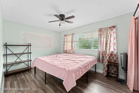 a bed sitting in a bedroom next to a window