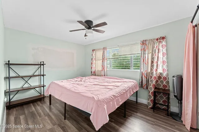 a bed sitting in a bedroom next to a window