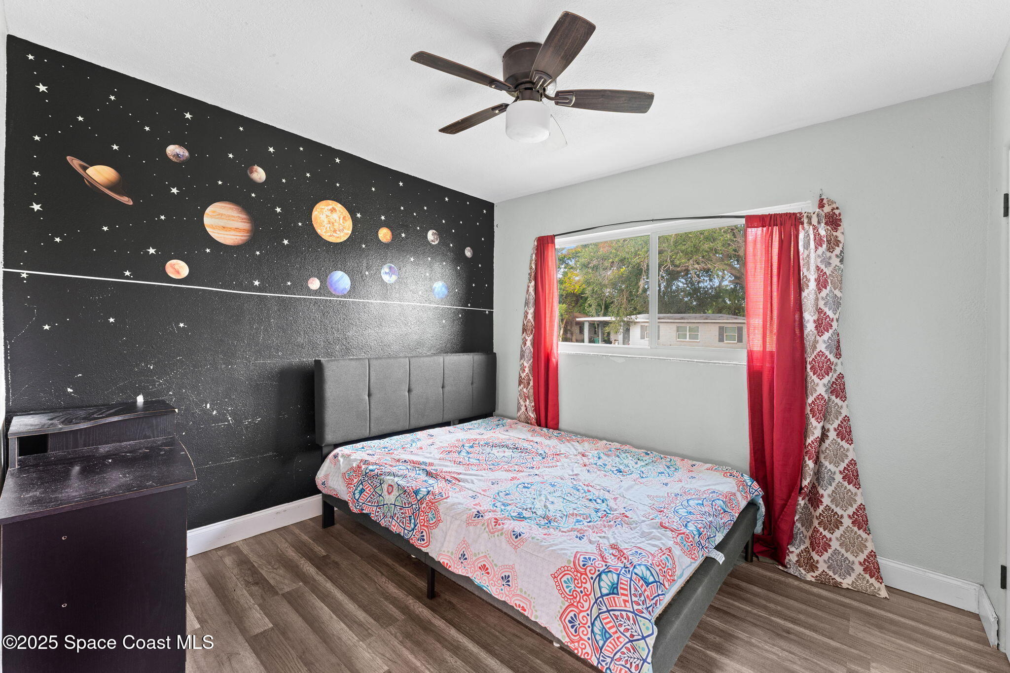 406 North Fiske Boulevard Cocoa, FL 32922 - Photo 13 of 21 a bedroom with a bed and a chandelier