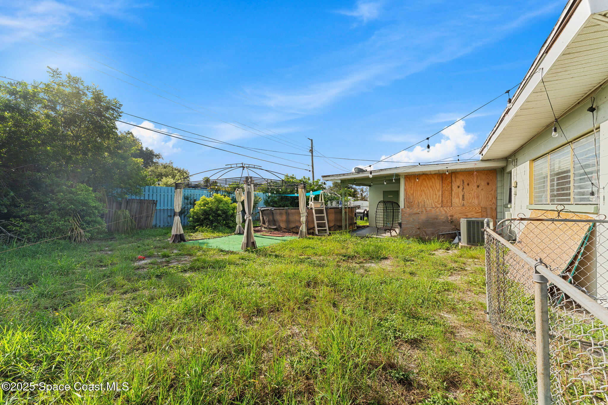 406 North Fiske Boulevard Cocoa, FL 32922 - Photo 15 of 21 a backyard of a house with plants and large tree