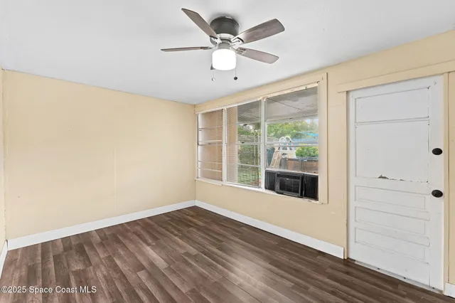 wooden floor in an empty room with a window