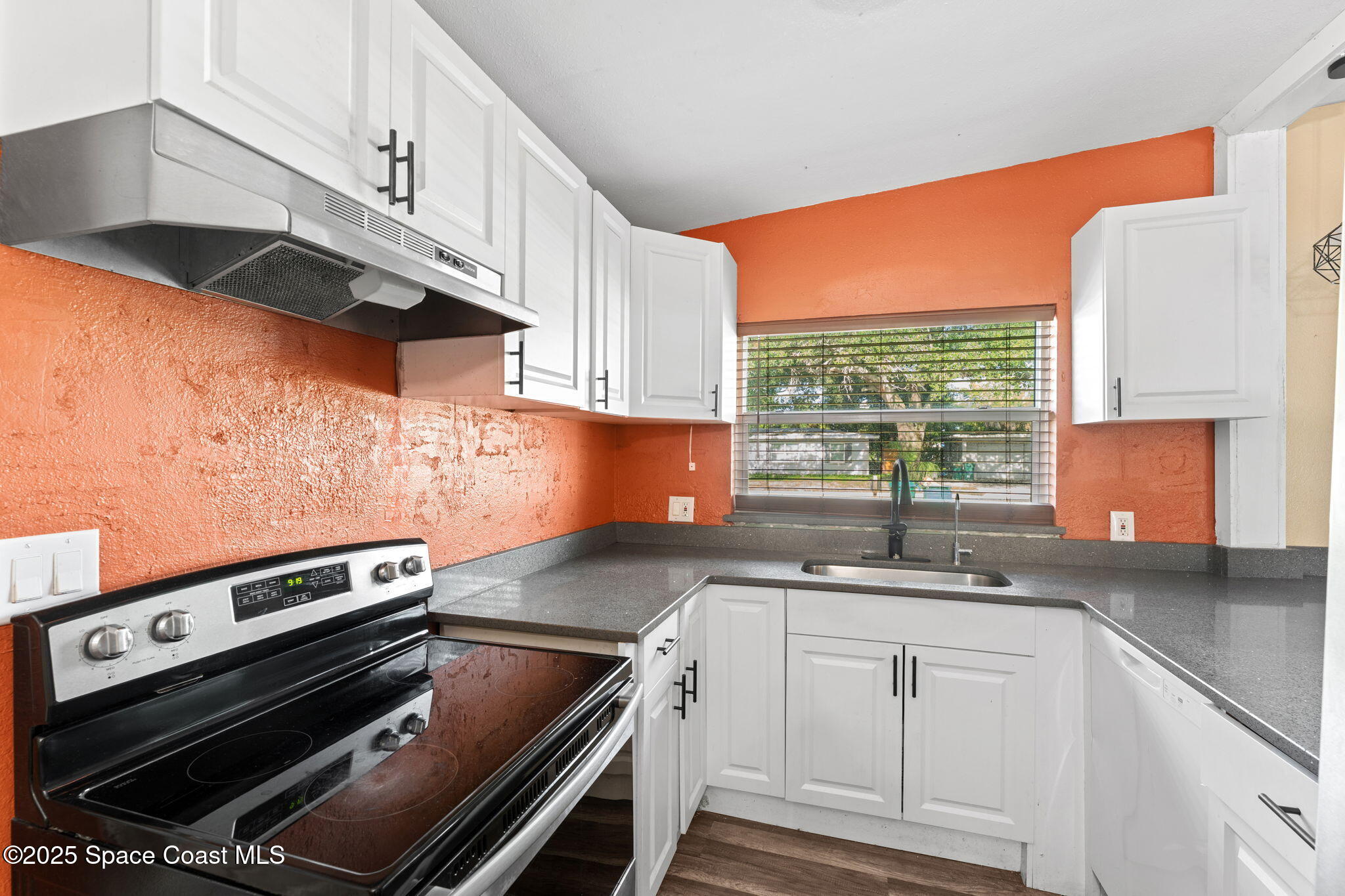 406 North Fiske Boulevard Cocoa, FL 32922 - Photo 7 of 21 a kitchen with a sink stove and cabinets
