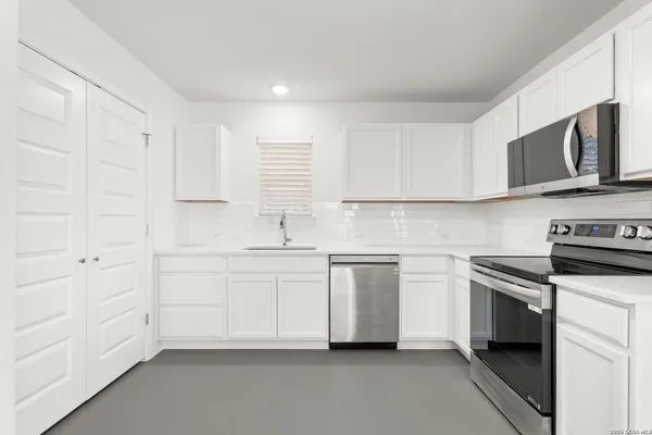 a view of a hallway with washer and dryer