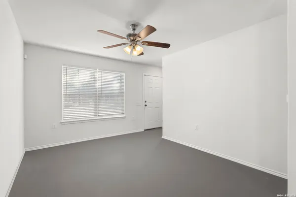a view of a livingroom with a ceiling fan and window