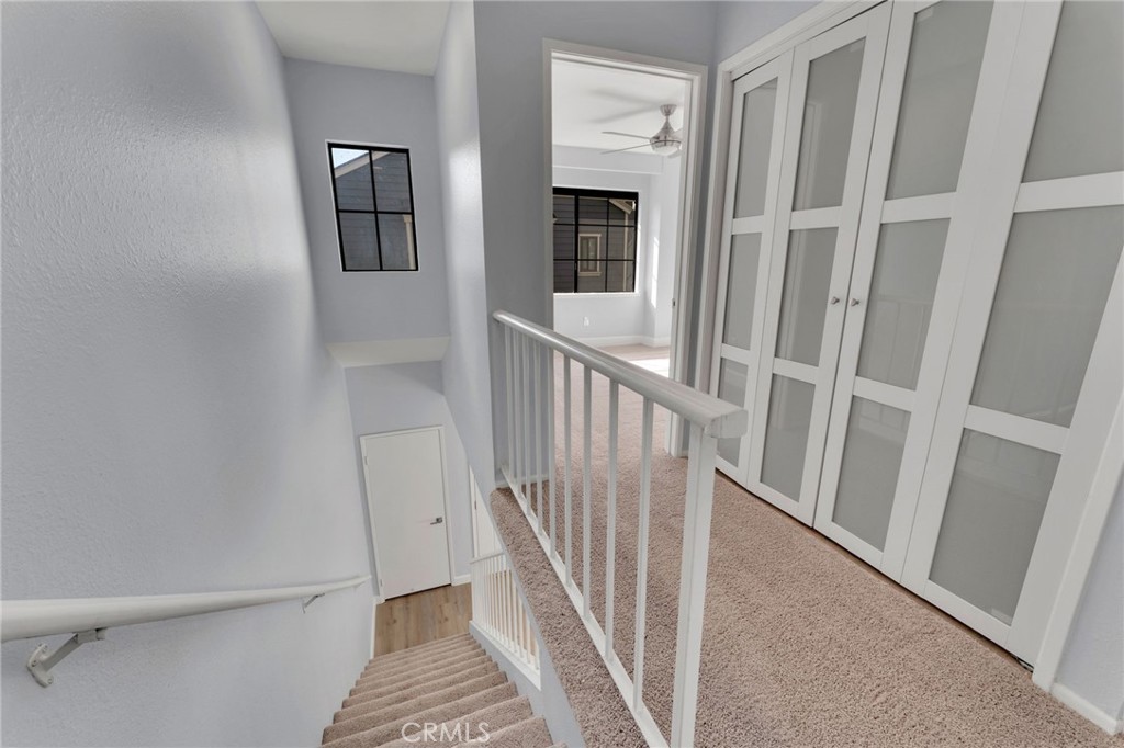 8703 Pine Crest Place Rancho Cucamonga, CA 91730 - Photo 15 of 36 a view of a hallway with wooden floor and stairs
