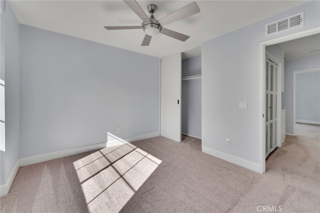 8703 Pine Crest Place Rancho Cucamonga, CA 91730 - Photo 17 of 36 an empty room with a ceiling fan and a rug
