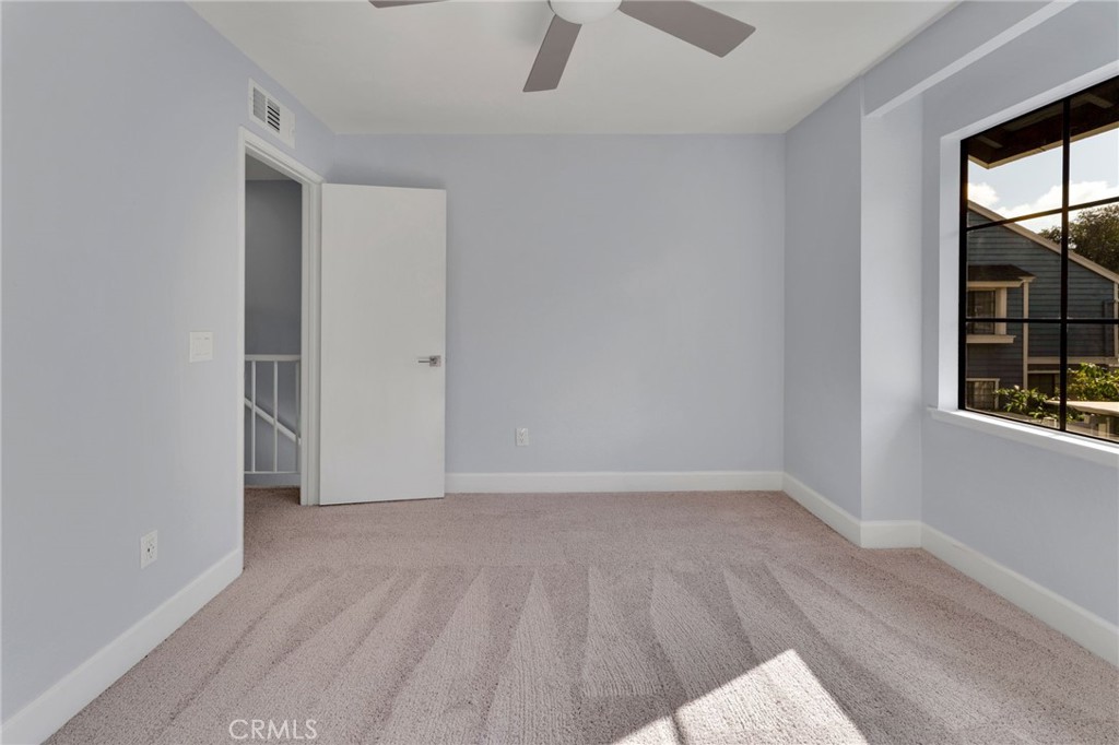 8703 Pine Crest Place Rancho Cucamonga, CA 91730 - Photo 18 of 36 a view of an empty room with window and wooden floor