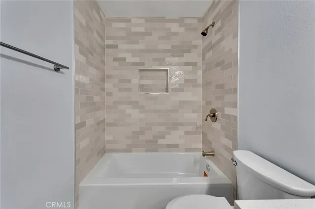 a bathroom with a bathtub and a toilet
