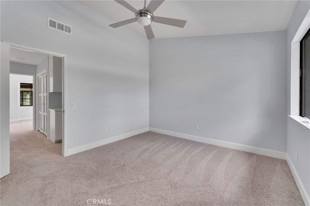 8703 Pine Crest Place Rancho Cucamonga, CA 91730 - Photo 22 of 36 an empty room with a ceiling fan and a window