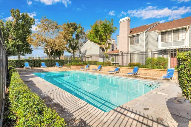 a swimming pool with outdoor seating and yard