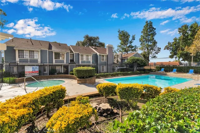 a view of a house with swimming pool and sitting area