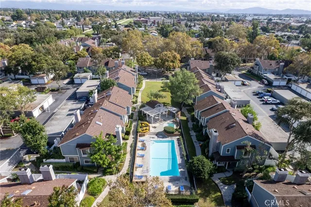 an aerial view of residential houses with outdoor space