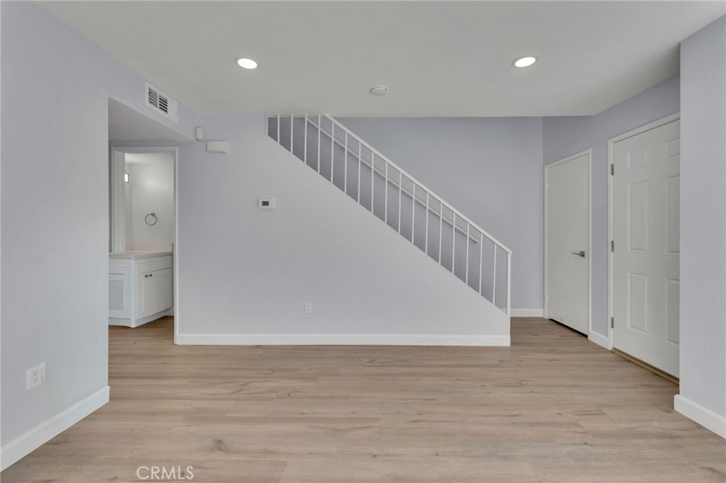 8703 Pine Crest Place Rancho Cucamonga, CA 91730 - Photo 6 of 36 a view of hallway with stairs and wooden floor