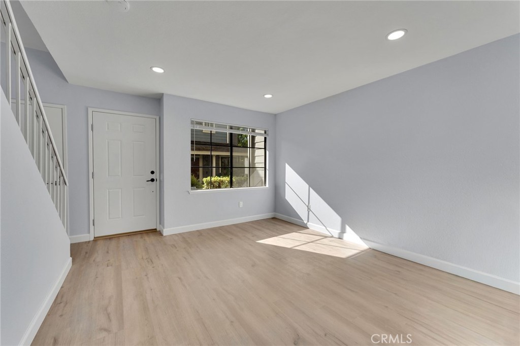 8703 Pine Crest Place Rancho Cucamonga, CA 91730 - Photo 7 of 36 an empty room with wooden floor and windows