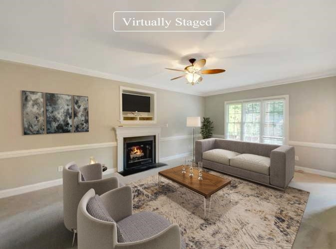 207 Normandy Drive Clayton, NC 27527 - Photo 2 of 25 a living room with furniture a fireplace and a flat screen tv