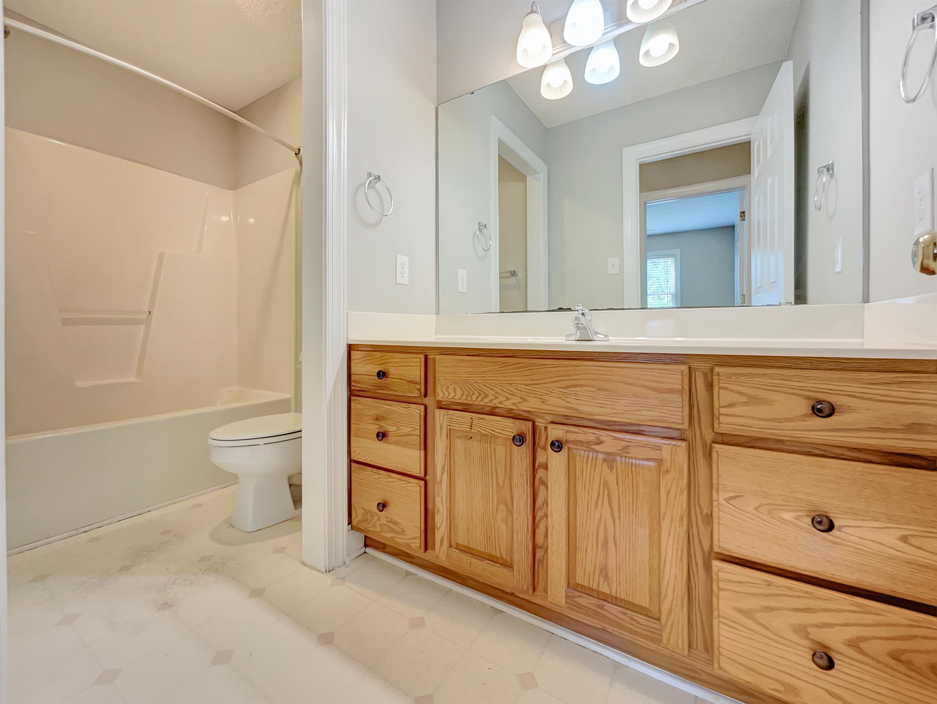 207 Normandy Drive Clayton, NC 27527 - Photo 22 of 25 a spacious bathroom with a double vanity sink a toilet a mirror and shower