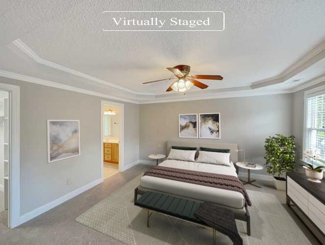 207 Normandy Drive Clayton, NC 27527 - Photo 3 of 25 a bedroom with a large bed and a chandelier