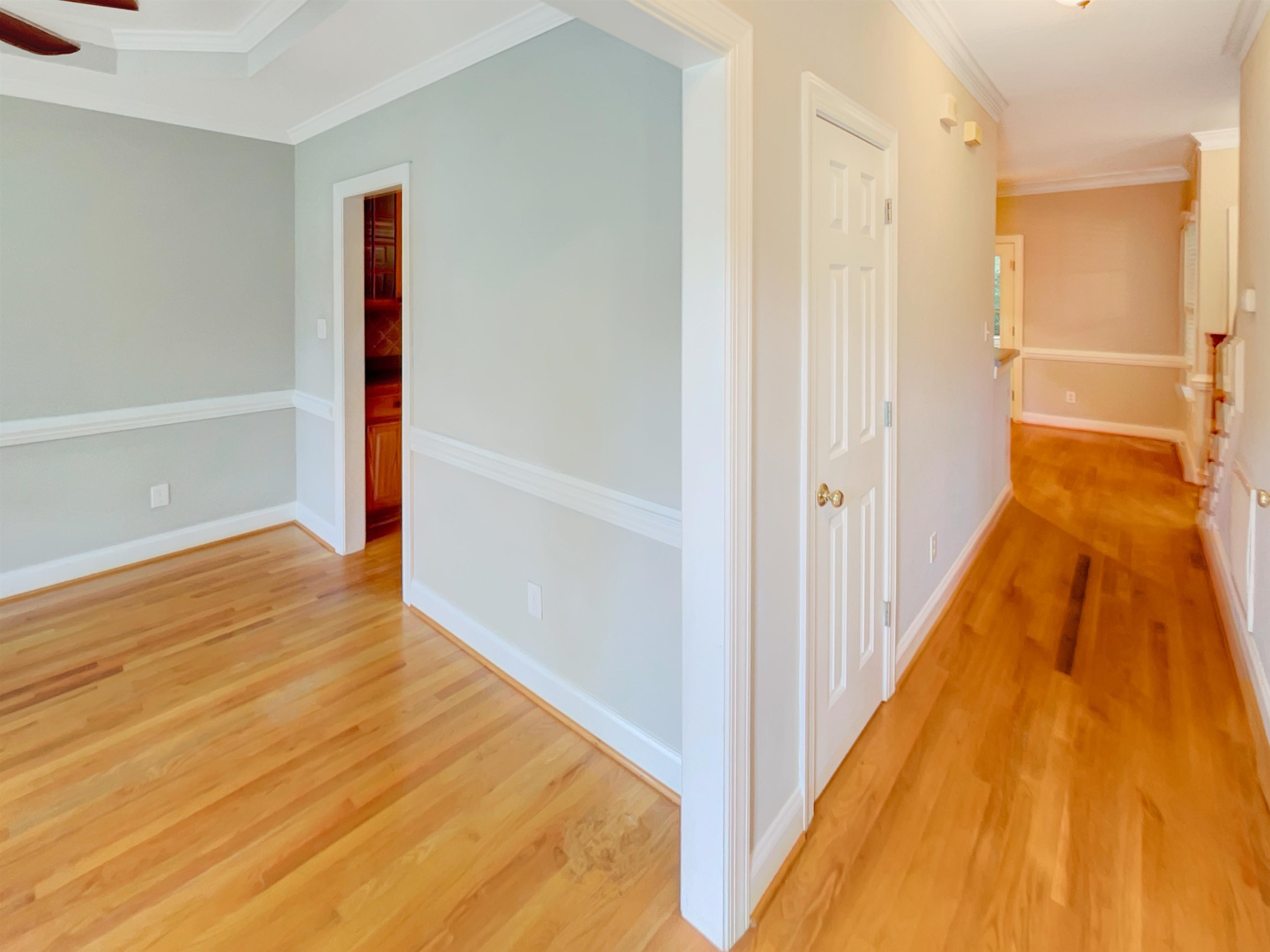 207 Normandy Drive Clayton, NC 27527 - Photo 8 of 25 a view of a hallway with wooden floor and a bathroom