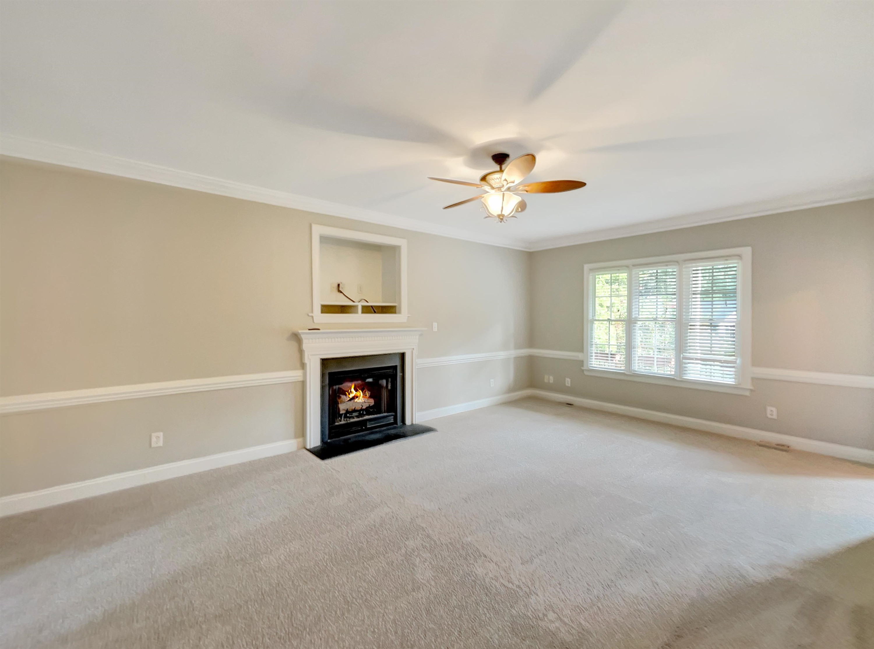 207 Normandy Drive Clayton, NC 27527 - Photo 9 of 25 a view of livingroom with a fireplace a ceiling fan and windows