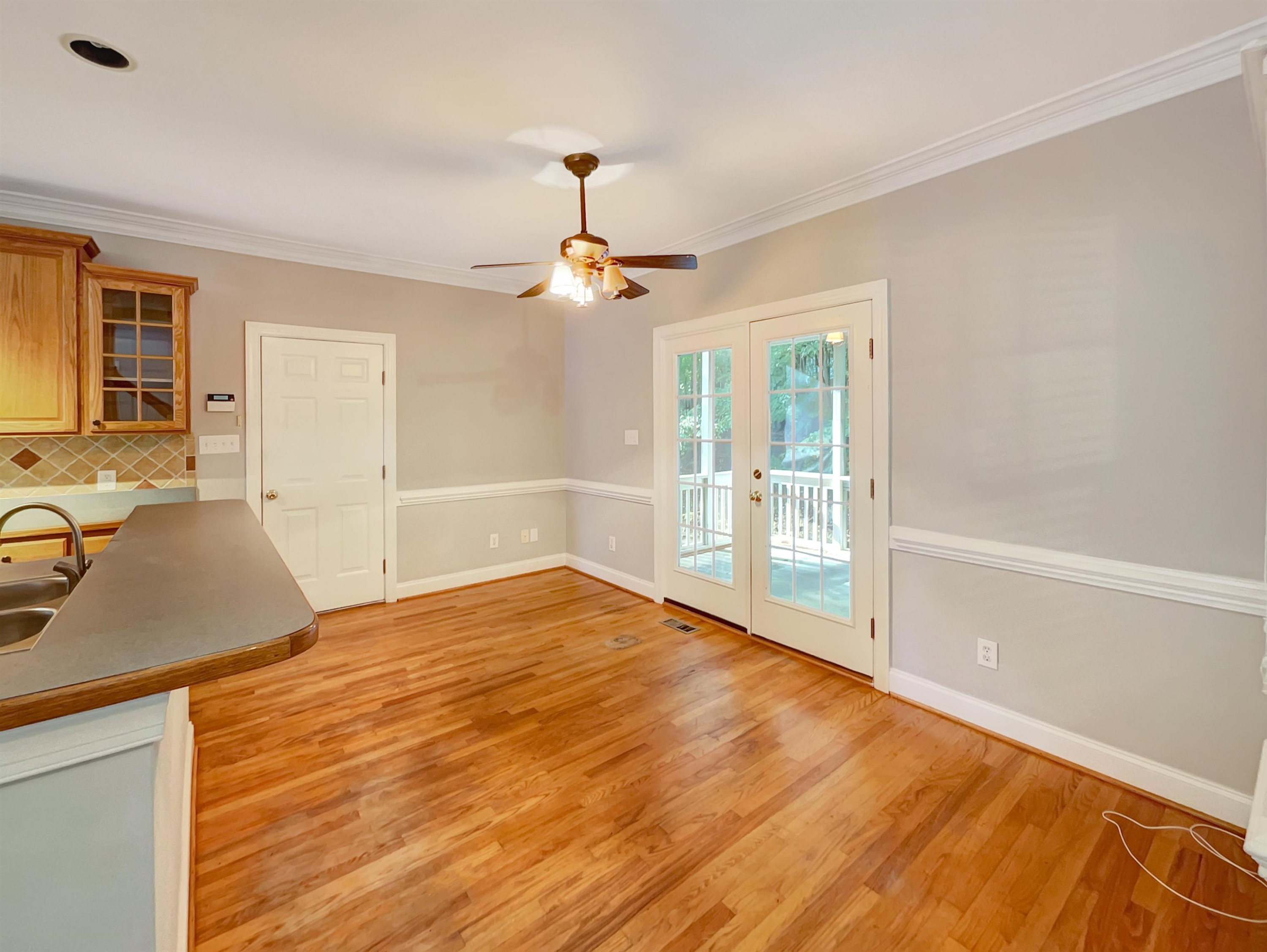 207 Normandy Drive Clayton, NC 27527 - Photo 10 of 25 a view of a room with wooden floor and ceiling fan
