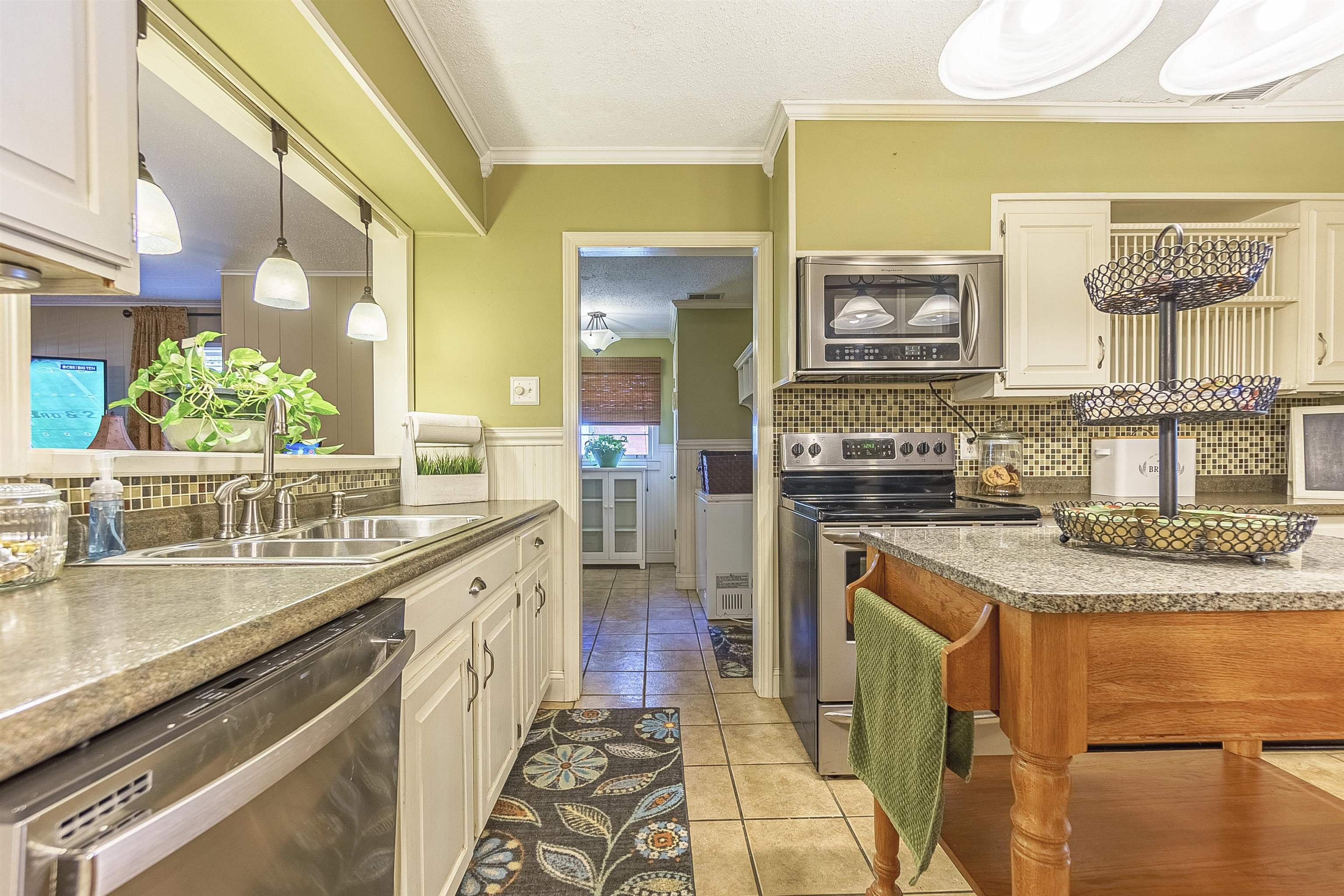 4476 Helene Road Memphis, TN 38117 - Photo 9 of 22 a kitchen with stainless steel appliances granite countertop a stove and a sink