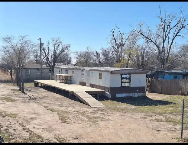 a view of a house with a yard covered in snow