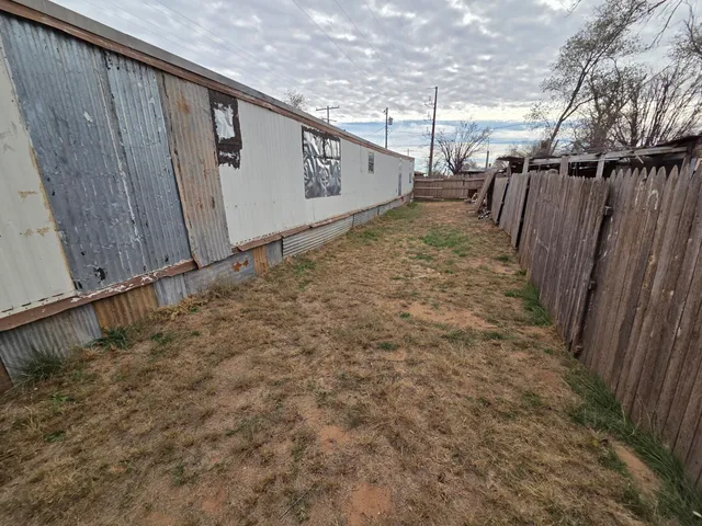 a view of a backyard with chairs