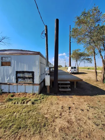 a view of a yard with wooden fence