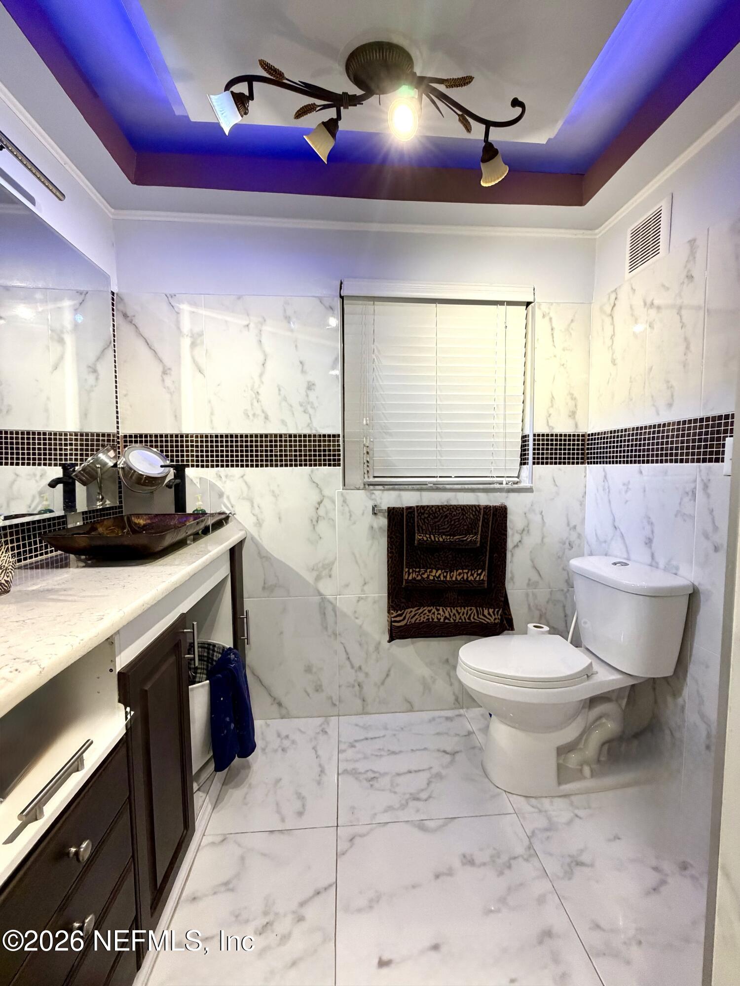 4127 Springwood Road Jacksonville, FL 32207 - Photo 31 of 63 a bathroom with a sink a toilet and a shower