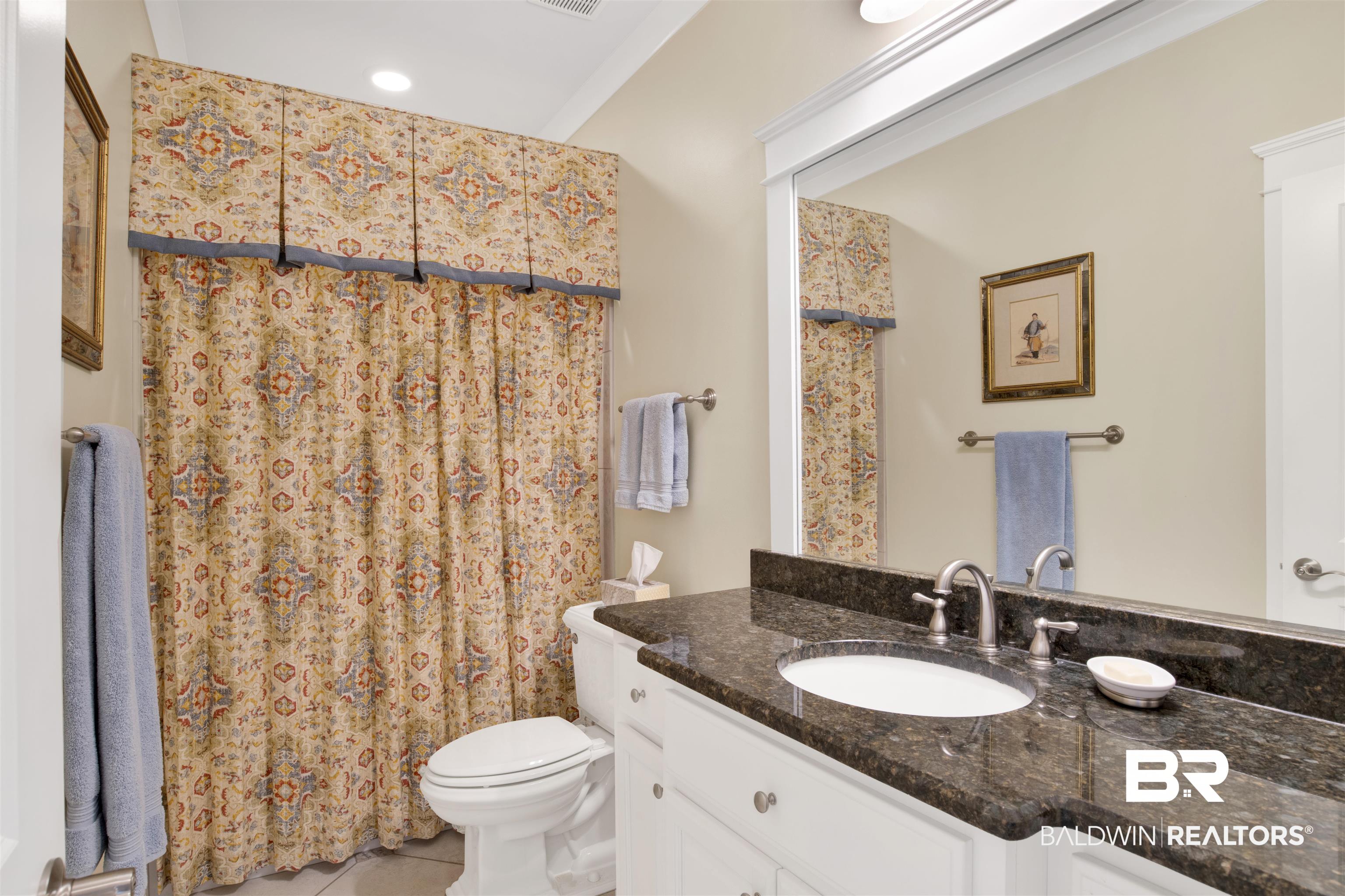 131 Sedgefield Avenue Fairhope, AL 36532 - Photo 21 of 50 2nd bathroom with tile patterned flooring, toilet, and vanity with granite countertop