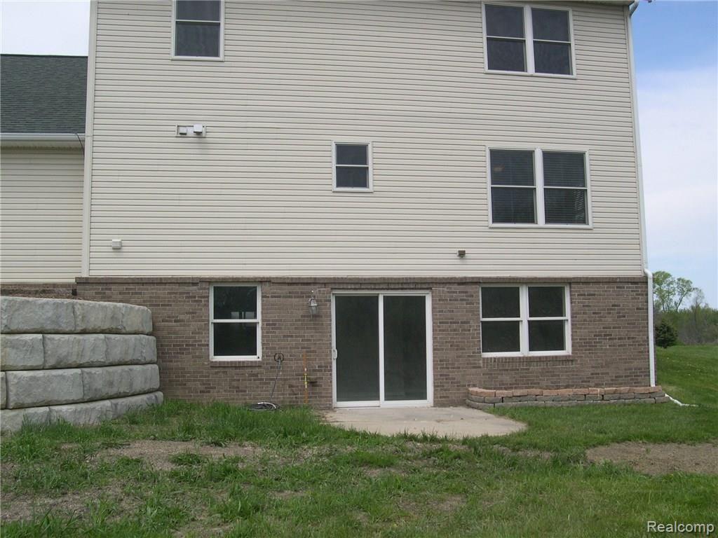 1047 Marsh Ridge Brighton, MI 48114 - Photo 5 of 25 WALK OUT ELEVATION TO PATIO